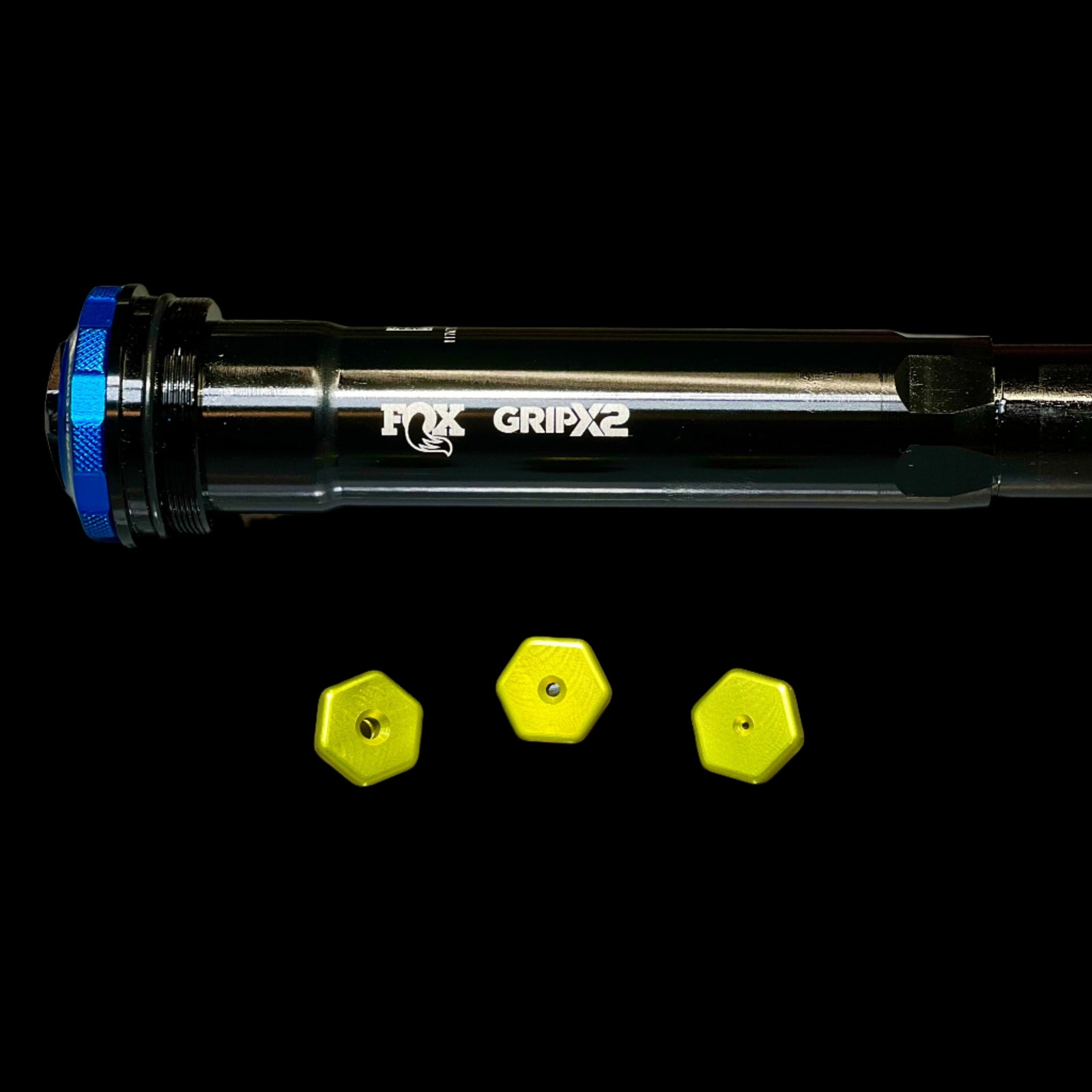 Fox GripX2 suspension fork with three yellow hex nuts on a white background